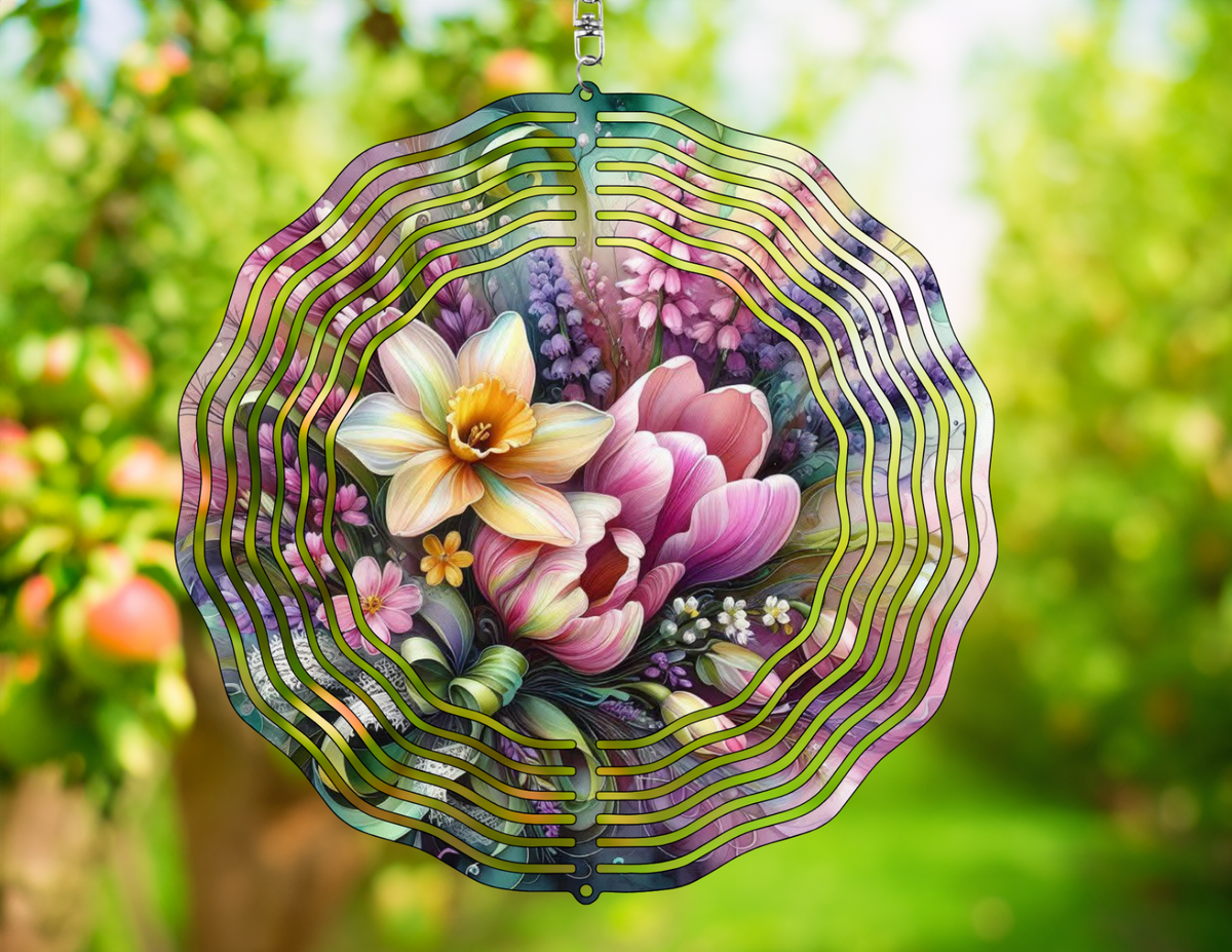 Decorative wind spinner with floral design against a blurred green outdoor background